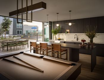 Community lounge featuring work pods, kitchen, media room, and pool table